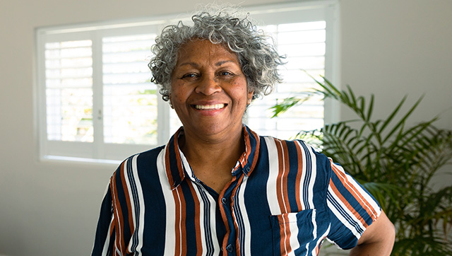 Senior woman comfortably smiling indoors